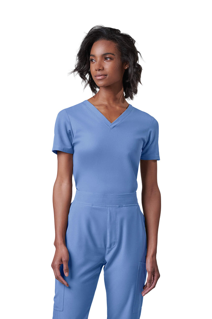 Woman wearing MedTailor women's scrub top in Sky Blue color fabric